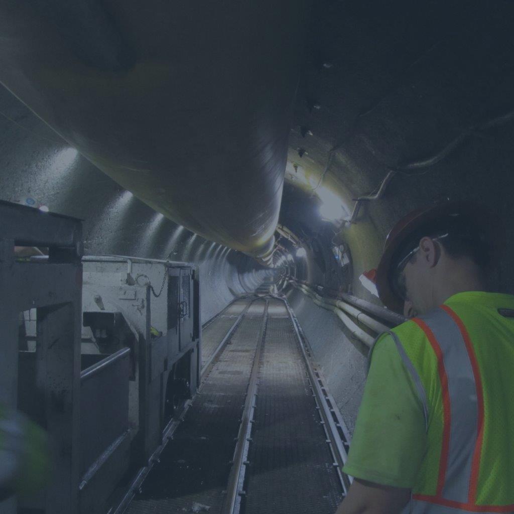 Tunnel worker inside long shaft