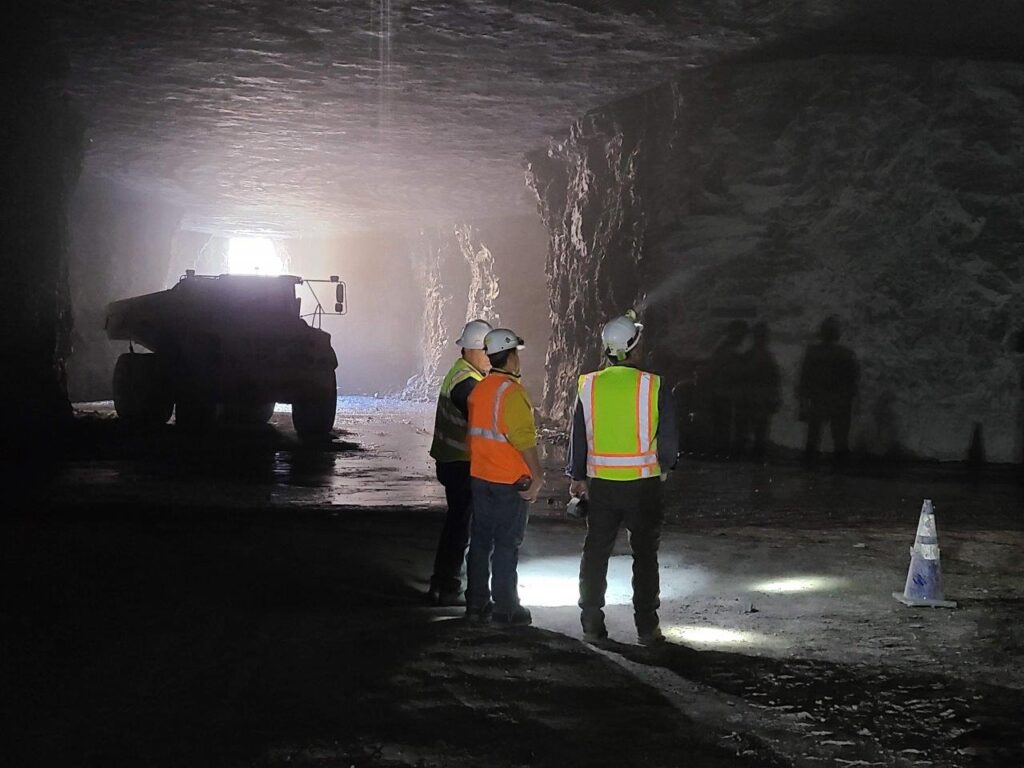 IWT stands with customers underground in a tunnel inspecting work