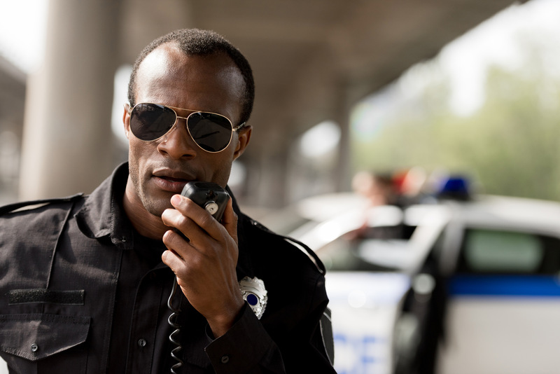 male police officer on speaker mic