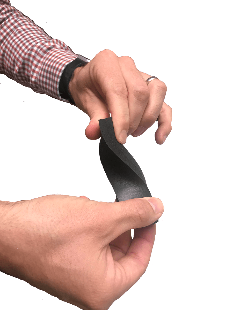 man's hands twist flexible foam rectangle