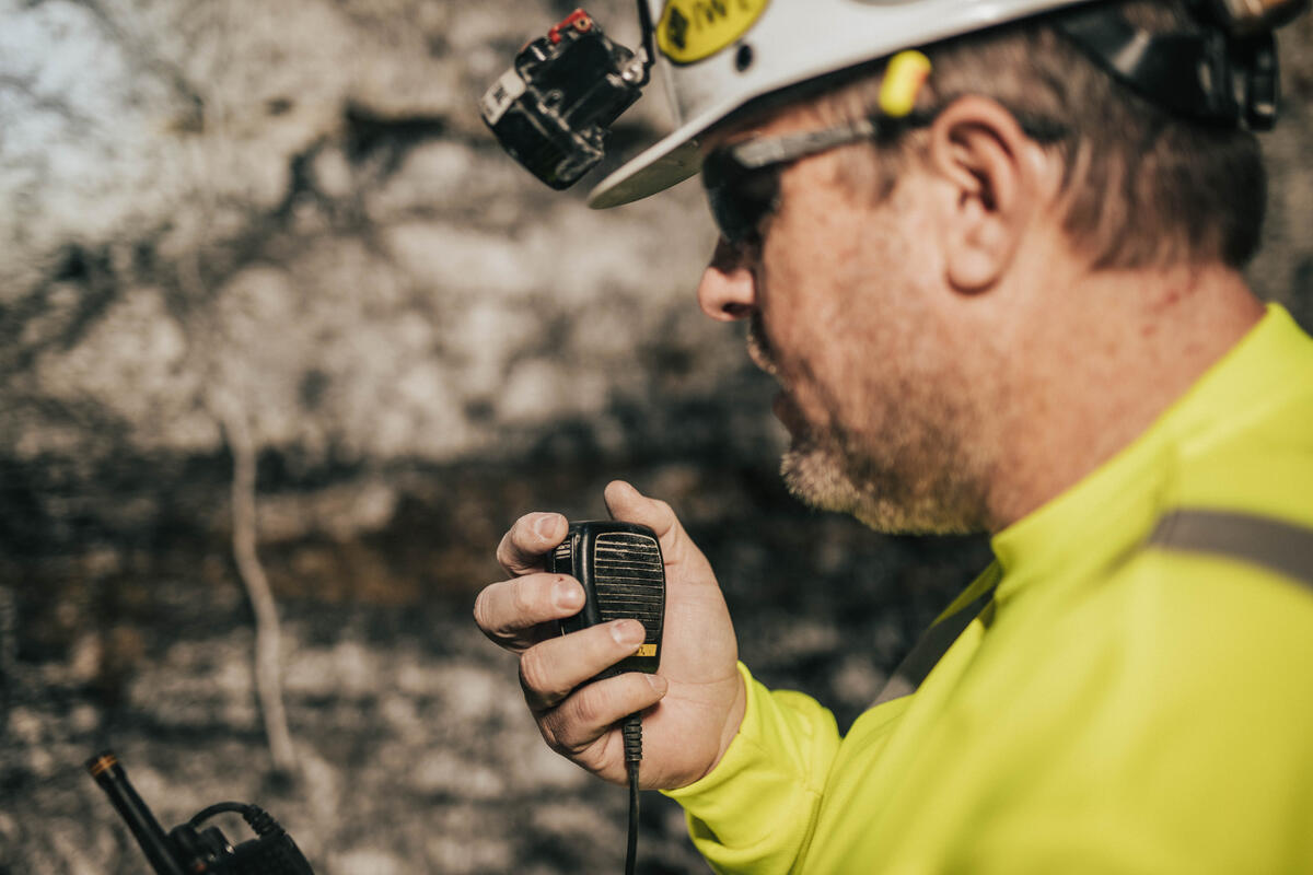 man in mine speaking on communications equipment