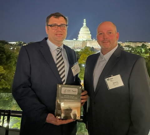 presenting award with capitol building in background